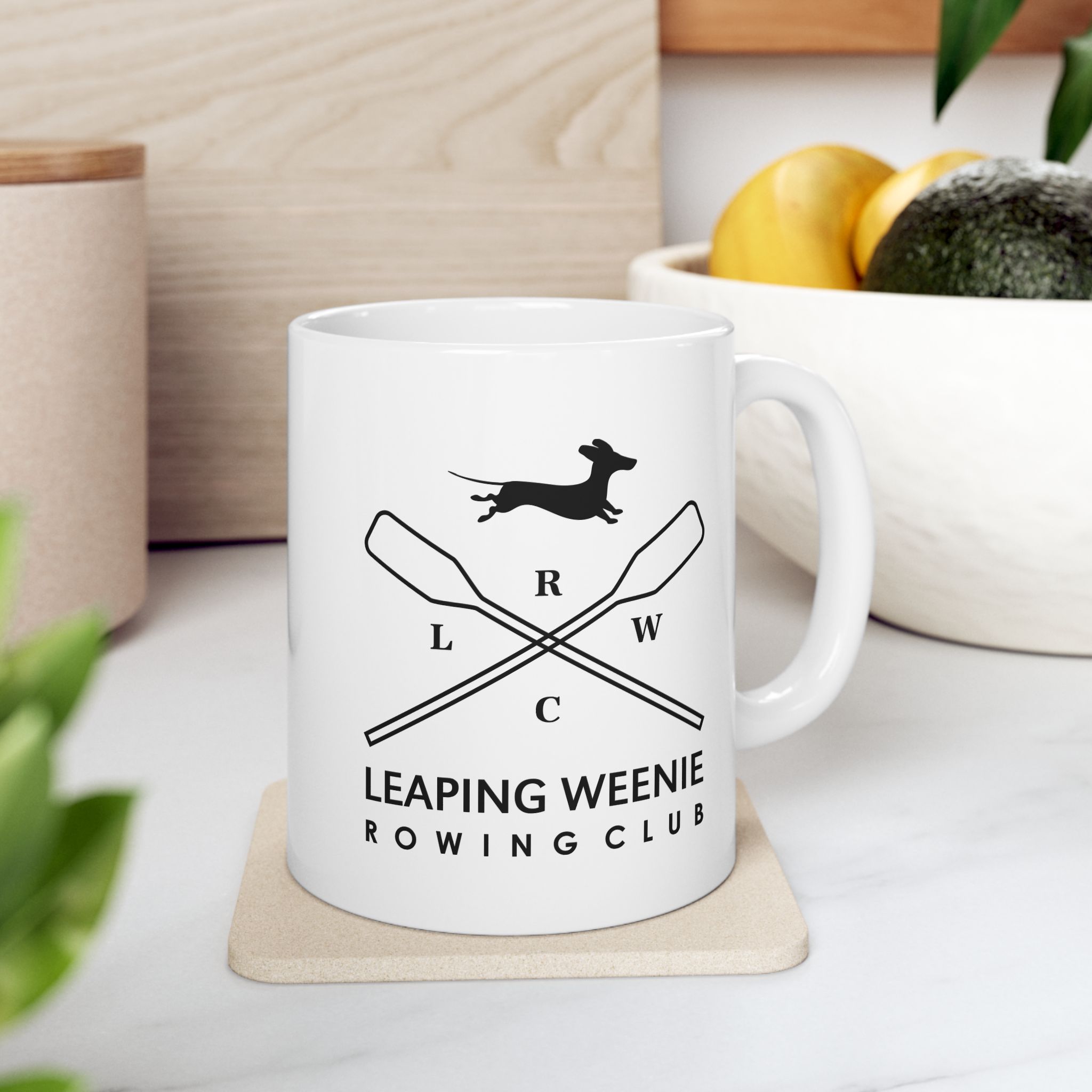 Glossy white ceramic mug with Leaping Weenie Rowing Club dachshund and crossed oars emblem