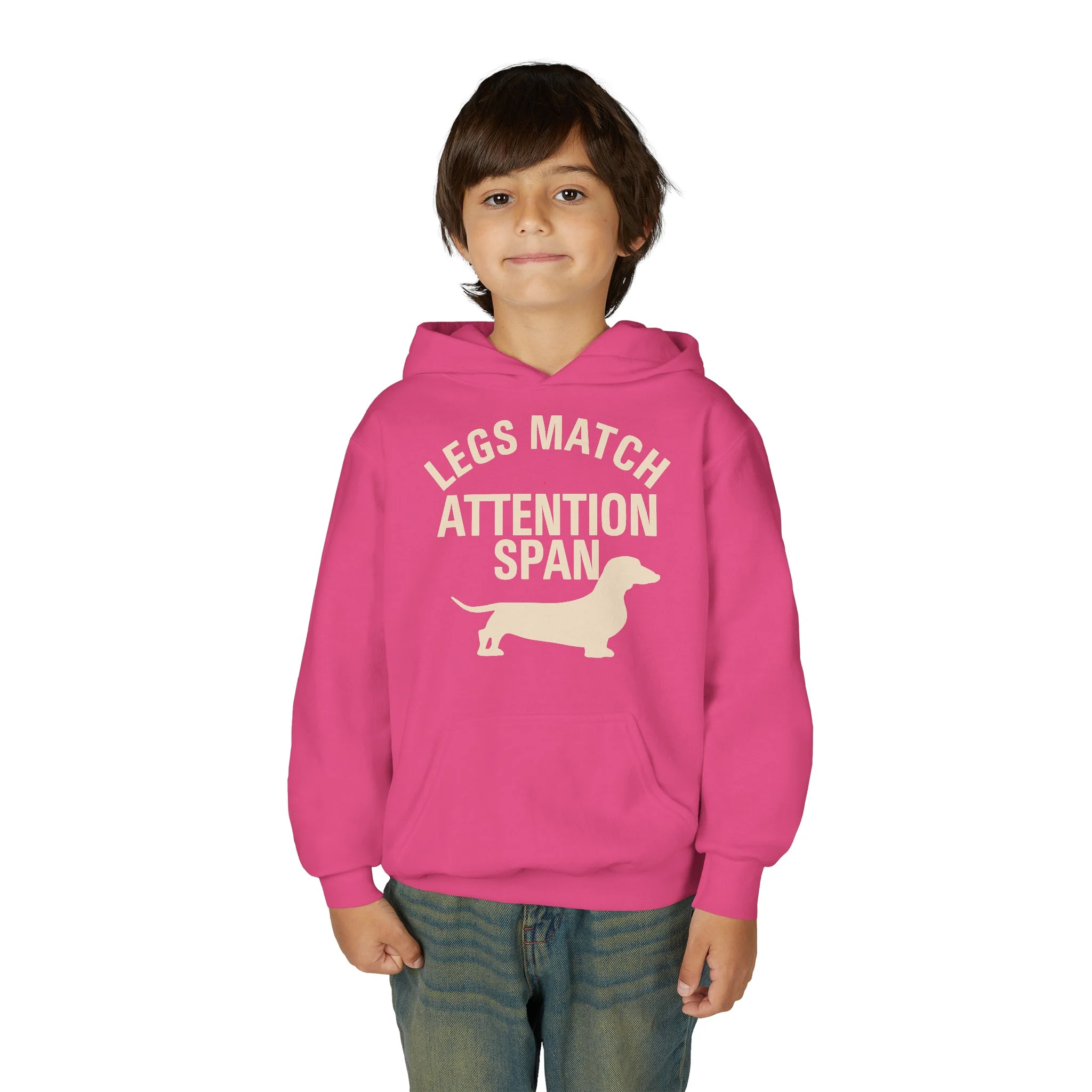 Child wearing a bright pink hoodie with cream slogan reading 'LEGS MATCH ATTENTION SPAN' and a dog silhouette, facing camera.